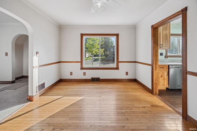 2509 Main St, Lafayette, IN 47904 - spare room with light wood-style flooring, arched walkways, ornamental molding, and baseboards