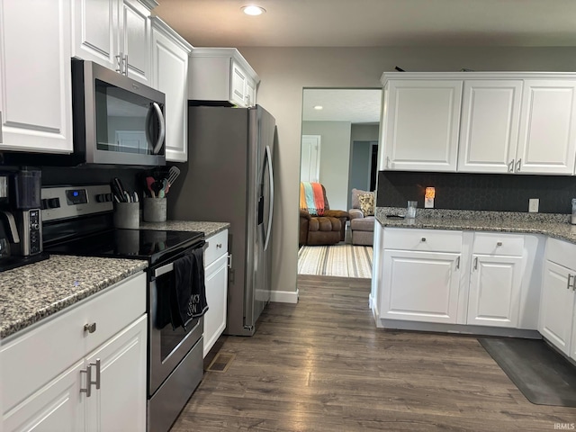 1264 W Greenbriar Dr, Washington, IN 47501 - kitchen with appliances with stainless steel finishes, white cabinetry, dark wood-style floors, recessed lighting, and light stone countertops