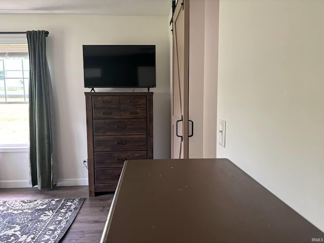 1264 W Greenbriar Dr, Washington, IN 47501 - bedroom with wood finished floors, baseboards, and a barn door