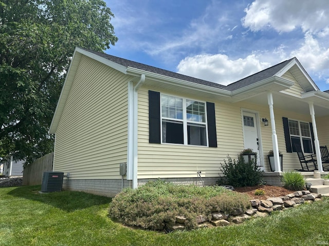 1264 W Greenbriar Dr, Washington, IN 47501 - view of front of property with a porch, a front yard, central AC unit, and a shingled roof