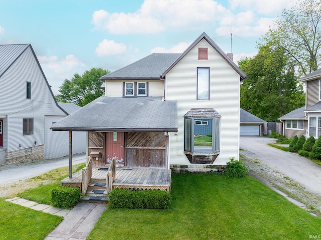 244 N Miami St, Wabash, IN 46992 - view of front of house with a front lawn, an outbuilding, a shingled roof, and a garage