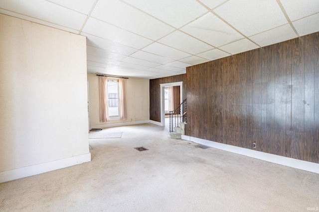 244 N Miami St, Wabash, IN 46992 - carpeted spare room with wood walls, a drop ceiling, baseboards, and stairway