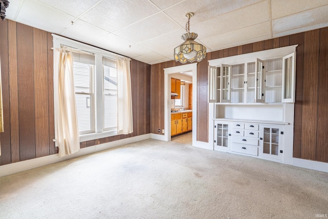 244 N Miami St, Wabash, IN 46992 - unfurnished dining area with wood walls, light colored carpet, and a drop ceiling