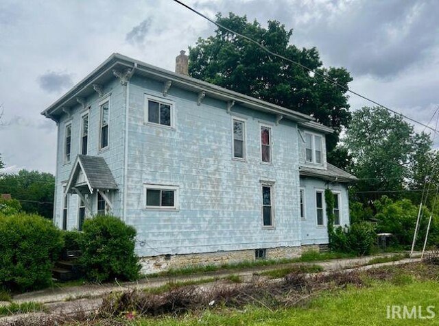 718 E Lewis St, Fort Wayne, IN 46802 - view of side of home featuring a chimney