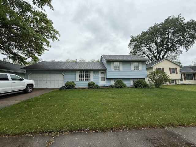 703 Downey Ave, Mishawaka, IN 46544 - tri-level home featuring an attached garage, a front lawn, and concrete driveway