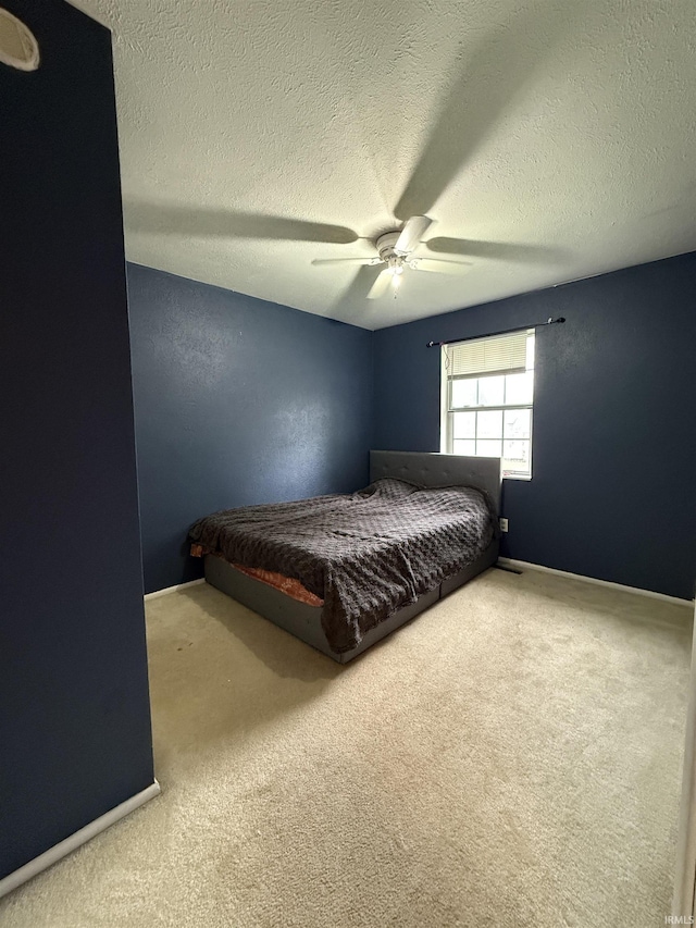 703 Downey Ave, Mishawaka, IN 46544 - bedroom with carpet flooring, ceiling fan, and a textured ceiling