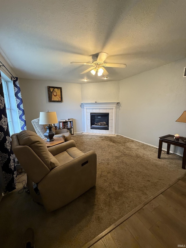 703 Downey Ave, Mishawaka, IN 46544 - living room with ceiling fan, a textured ceiling, and a fireplace
