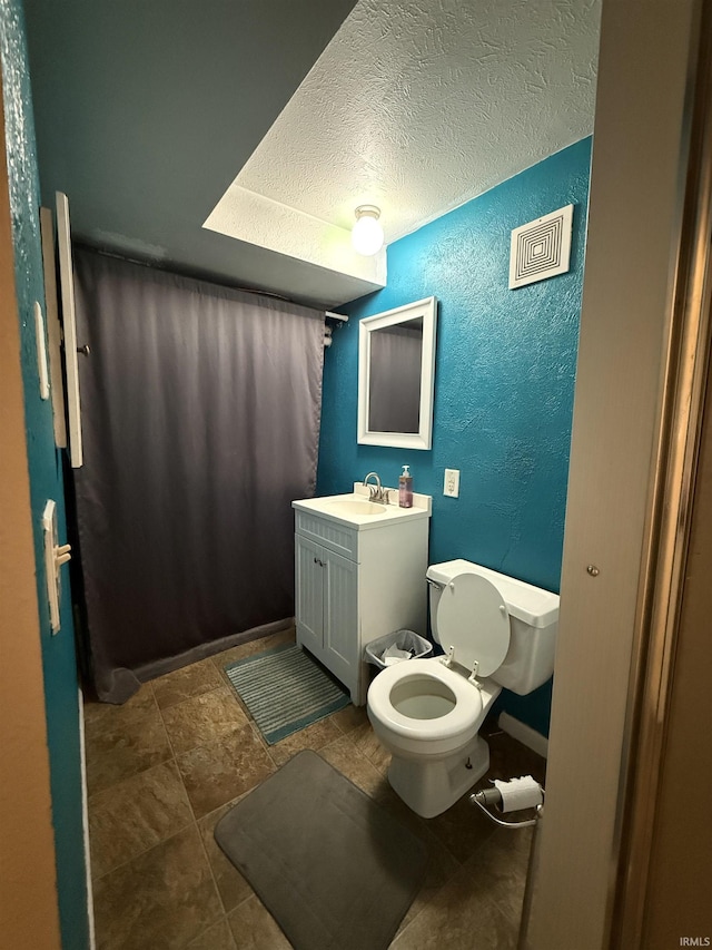 703 Downey Ave, Mishawaka, IN 46544 - bathroom with a textured wall, vanity, toilet, and a textured ceiling