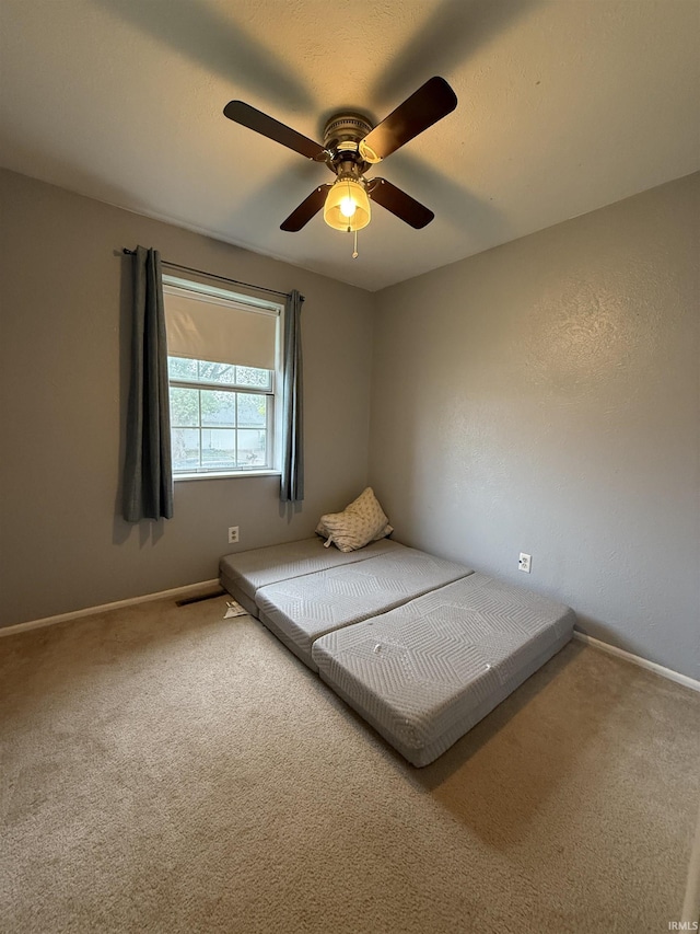 703 Downey Ave, Mishawaka, IN 46544 - unfurnished bedroom featuring carpet floors, baseboards, and a ceiling fan