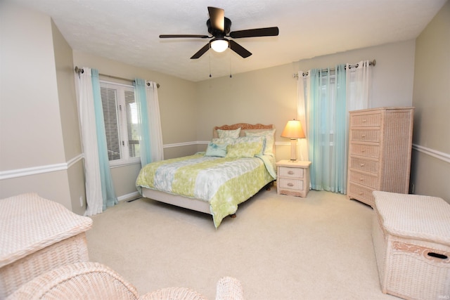 9763 S Harbour Pointe Dr Unit 34, Bloomington, IN 47401 - bedroom with light carpet, ceiling fan, and baseboards