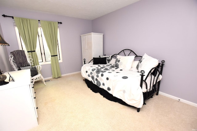 9763 S Harbour Pointe Dr Unit 34, Bloomington, IN 47401 - bedroom featuring light carpet and baseboards