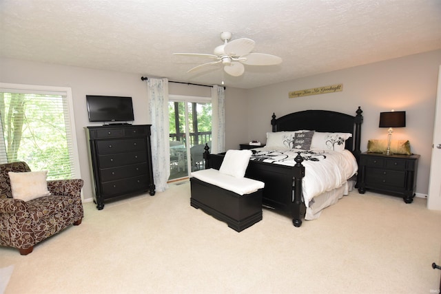 9763 S Harbour Pointe Dr Unit 34, Bloomington, IN 47401 - bedroom with access to outside, light carpet, a textured ceiling, and ceiling fan