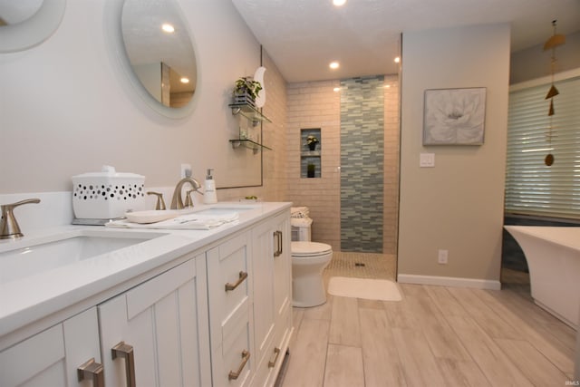 9763 S Harbour Pointe Dr Unit 34, Bloomington, IN 47401 - full bathroom featuring tiled shower, double vanity, toilet, recessed lighting, and a soaking tub