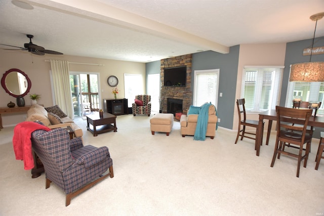 9763 S Harbour Pointe Dr Unit 34, Bloomington, IN 47401 - living area with carpet flooring, ceiling fan, a fireplace, and beam ceiling