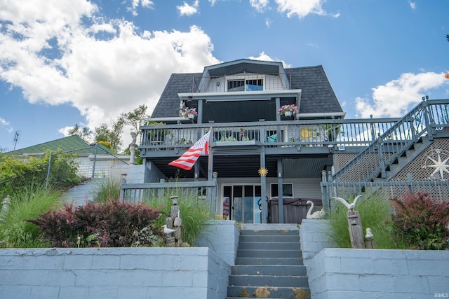 536 Garfield St, Osceola, IN 46561 - view of front facade featuring stairway, a deck, and a hot tub