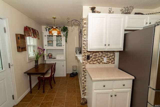 536 Garfield St, Osceola, IN 46561 - kitchen featuring freestanding refrigerator, white cabinetry, light countertops, and tasteful backsplash