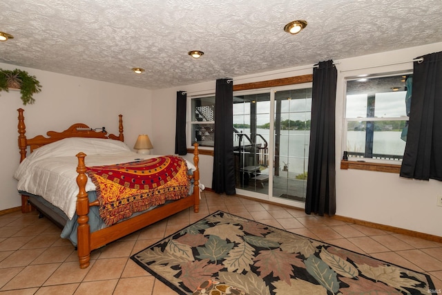 536 Garfield St, Osceola, IN 46561 - bedroom with access to exterior, light tile patterned floors, baseboards, and a textured ceiling