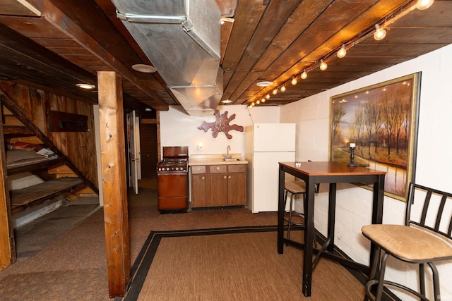 536 Garfield St, Osceola, IN 46561 - finished basement with freestanding refrigerator, a sink, and dark carpet