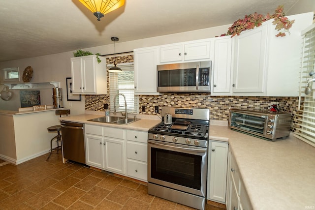 536 Garfield St, Osceola, IN 46561 - kitchen featuring stainless steel appliances, a sink, light countertops, and white cabinetry