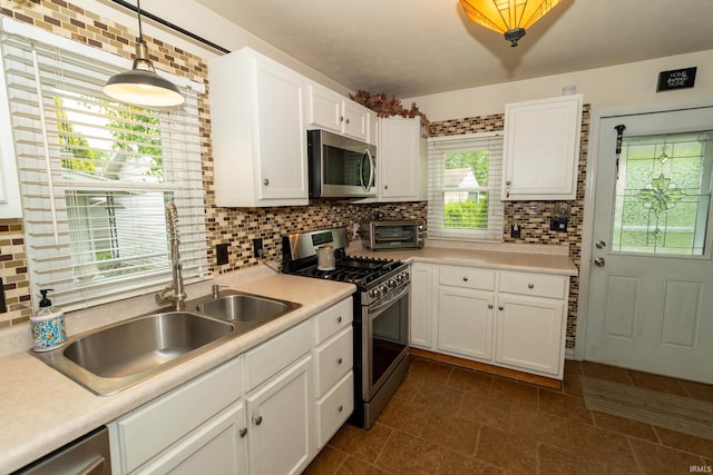 536 Garfield St, Osceola, IN 46561 - kitchen with appliances with stainless steel finishes, white cabinets, tasteful backsplash, and light countertops