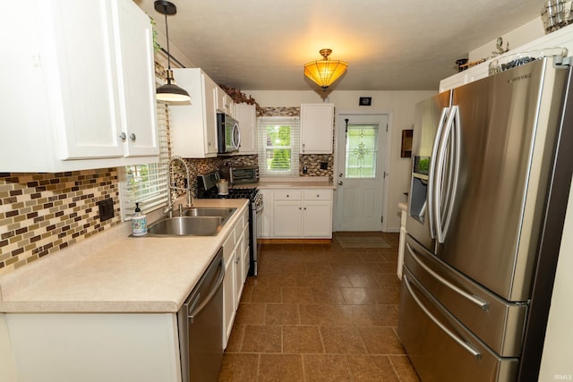 536 Garfield St, Osceola, IN 46561 - kitchen with stainless steel appliances, a sink, white cabinetry, decorative backsplash, and light countertops