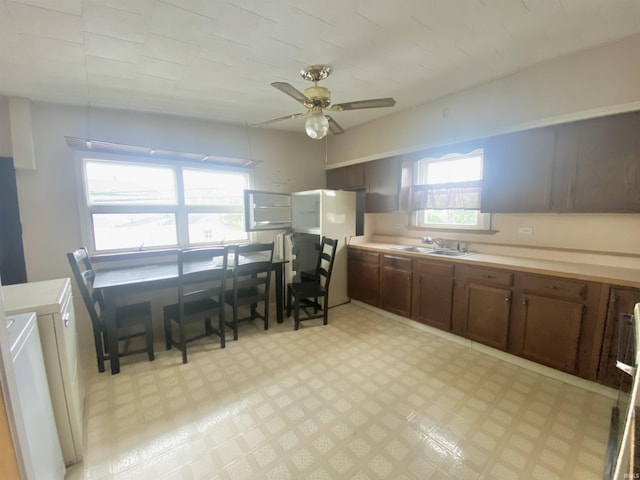 146 W Washington St, Parker City, IN 47368 - kitchen featuring a sink, a ceiling fan, light flooring, light countertops, and washer / dryer