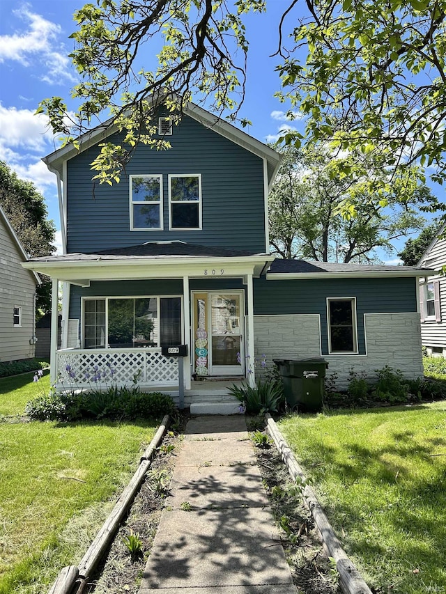 809 S Logan St, South Bend, IN 46615 - traditional home featuring a front yard, covered porch, and stone siding