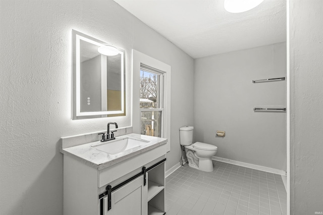 809 S Logan St, South Bend, IN 46615 - bathroom with tile patterned flooring, toilet, vanity, and baseboards