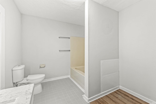809 S Logan St, South Bend, IN 46615 - bathroom with toilet, a bath, vanity, baseboards, and a textured ceiling