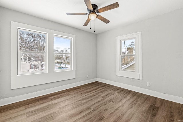 809 S Logan St, South Bend, IN 46615 - unfurnished room featuring wood finished floors, baseboards, and a ceiling fan