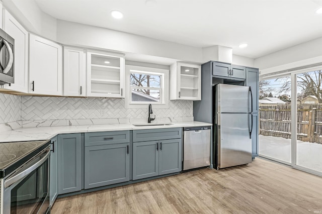 809 S Logan St, South Bend, IN 46615 - kitchen with stainless steel appliances, a sink, light wood-style floors, backsplash, and recessed lighting