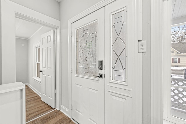 809 S Logan St, South Bend, IN 46615 - entrance foyer with dark wood-style flooring, crown molding, and baseboards