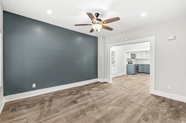 809 S Logan St, South Bend, IN 46615 - unfurnished room with a ceiling fan, baseboards, recessed lighting, and wood finished floors