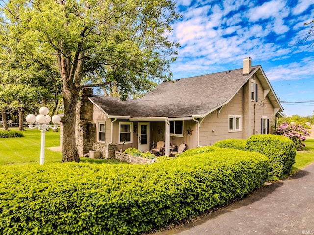 2770 S Andrews Rd, Yorktown, IN 47396 - view of front facade featuring a chimney, a shingled roof, and board and batten siding