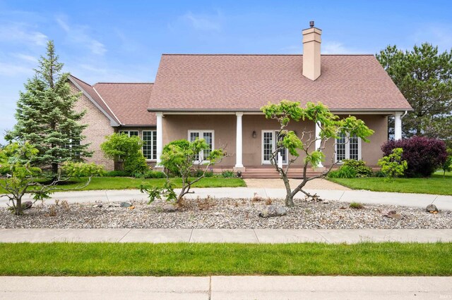 45 Stonebridge Dr, Winchester, IN 47394 - view of front of property with a chimney, stucco siding, a porch, and roof with shingles