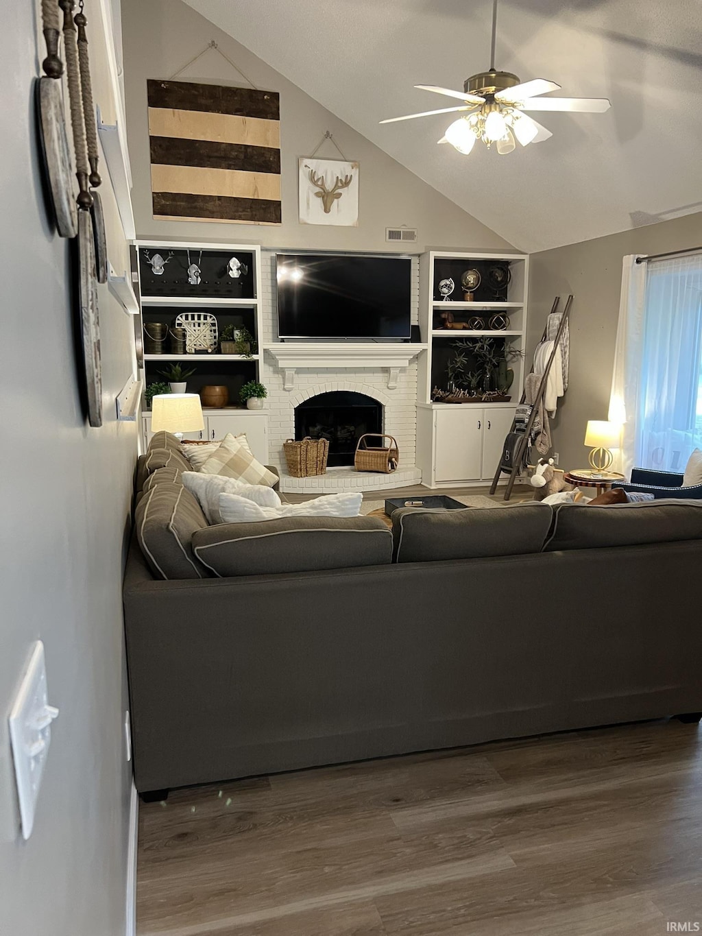 1130 Skyline Pass, Fort Wayne, IN 46825 - living room with a ceiling fan, a fireplace, vaulted ceiling, wood finished floors, and built in features