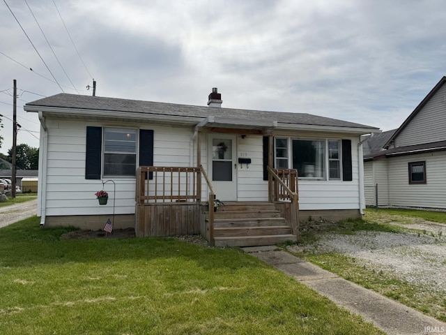 219 S 3rd St, Gas City, IN 46933 - view of front facade with a chimney and a front lawn