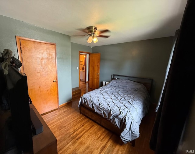 219 S 3rd St, Gas City, IN 46933 - bedroom featuring wood finished floors, a textured wall, a ceiling fan, and baseboards
