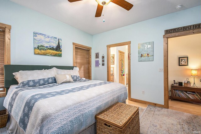 7185 N 1150 W, Shipshewana, IN 46565 - bedroom featuring light wood finished floors, baseboards, a ceiling fan, and ensuite bath