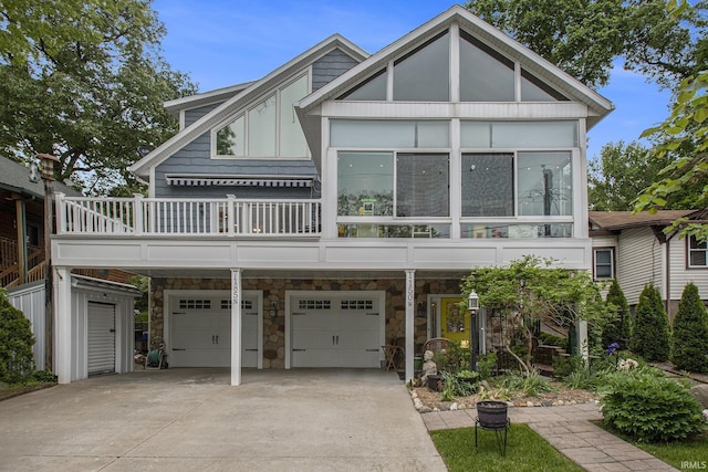 7185 N 1150 W, Shipshewana, IN 46565 - view of front of property featuring a garage, concrete driveway, and stone siding