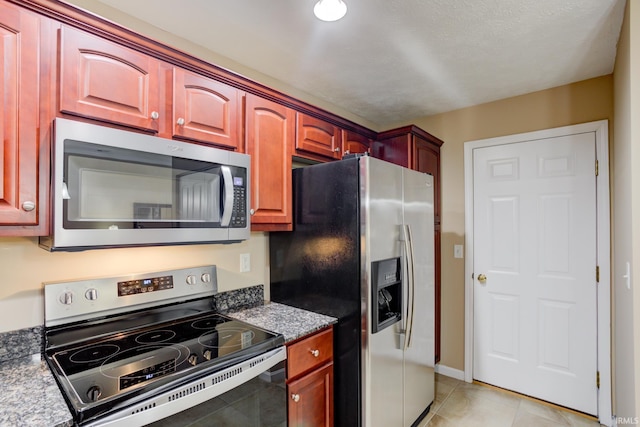 3033 Tory Ct, Evansville, IN 47715 - kitchen with appliances with stainless steel finishes, light tile patterned flooring, and dark brown cabinets