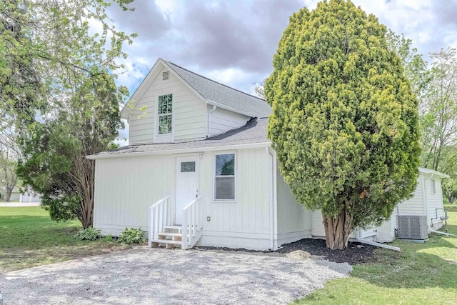 4280 S 1170 E, Lagrange, IN 46761 - view of front of house featuring entry steps, a shingled roof, a front lawn, and central air condition unit