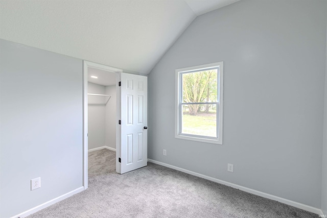 4280 S 1170 E, Lagrange, IN 46761 - unfurnished bedroom featuring carpet floors, lofted ceiling, baseboards, a walk in closet, and a closet