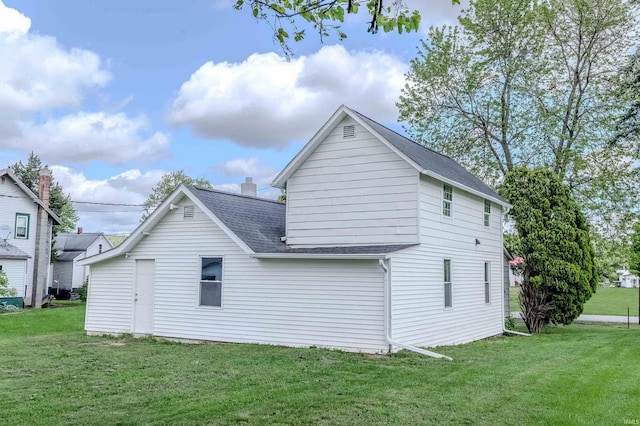 4280 S 1170 E, Lagrange, IN 46761 - view of side of home with a yard and a shingled roof