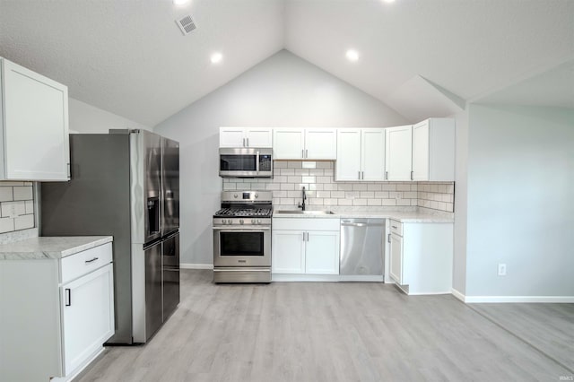 4280 S 1170 E, Lagrange, IN 46761 - kitchen featuring stainless steel appliances, a sink, light wood-style floors, tasteful backsplash, and white cabinetry