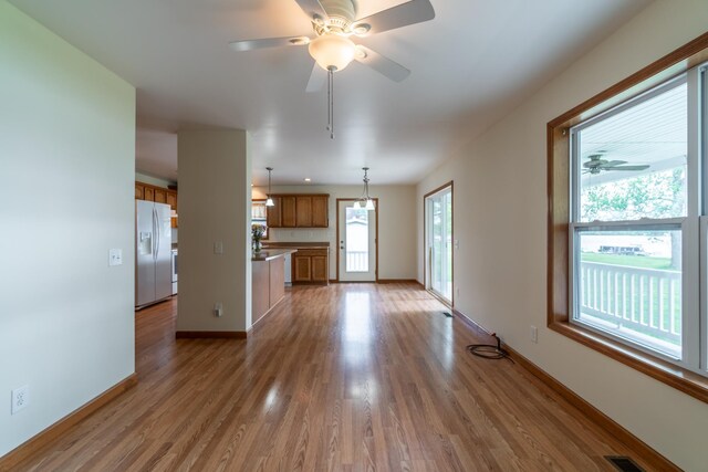 3775 W Columbia St, Columbia City, IN 46725 - unfurnished living room with a ceiling fan, wood finished floors, and baseboards