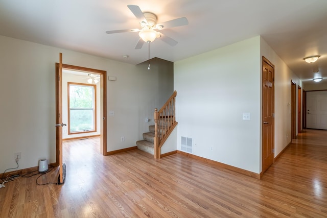 3775 W Columbia St, Columbia City, IN 46725 - unfurnished room featuring stairs, light wood-style flooring, ceiling fan, and baseboards