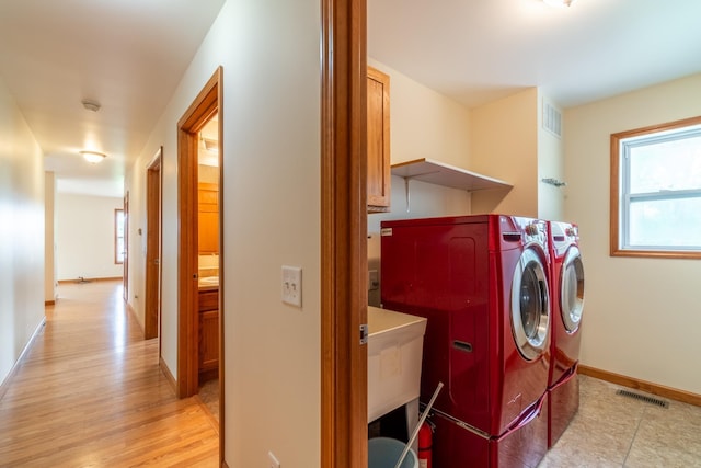 3775 W Columbia St, Columbia City, IN 46725 - laundry area featuring washer and clothes dryer, healthy amount of natural light, light wood-style flooring, and baseboards