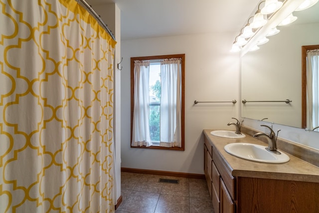 3775 W Columbia St, Columbia City, IN 46725 - full bathroom featuring double vanity, tile patterned flooring, baseboards, and curtained shower