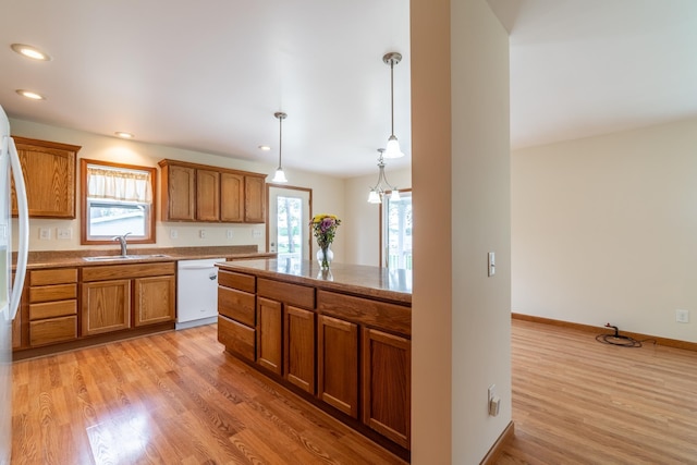 3775 W Columbia St, Columbia City, IN 46725 - kitchen with white appliances, a sink, brown cabinets, light wood finished floors, and recessed lighting